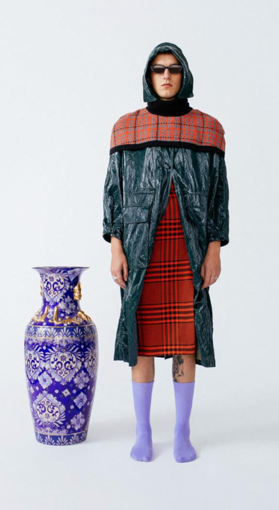A man wearing a futuristic outfit and lavender Socksss nearly up to his knees