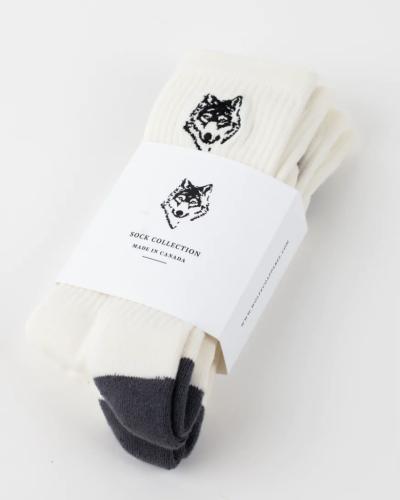 A three-pack of white Wolfe socks with a drawing of a wolf on each
