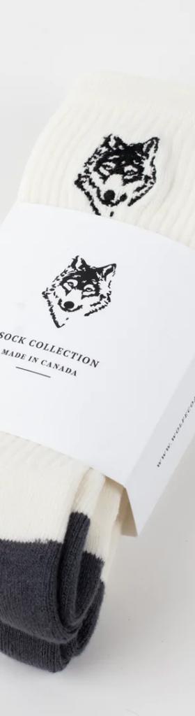 A three-pack of white Wolfe socks with a drawing of a wolf on each