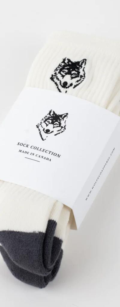 A three-pack of white Wolfe socks with a drawing of a wolf on each