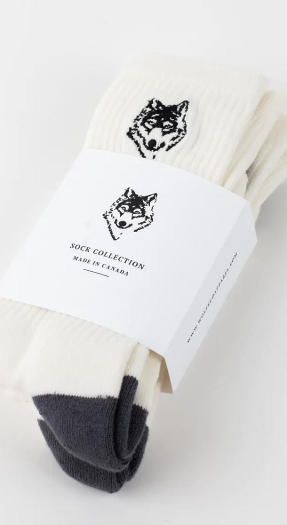 A three-pack of white Wolfe socks with a drawing of a wolf on each