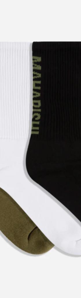 Green, white and blacks Marahishi crew socks on a white background
