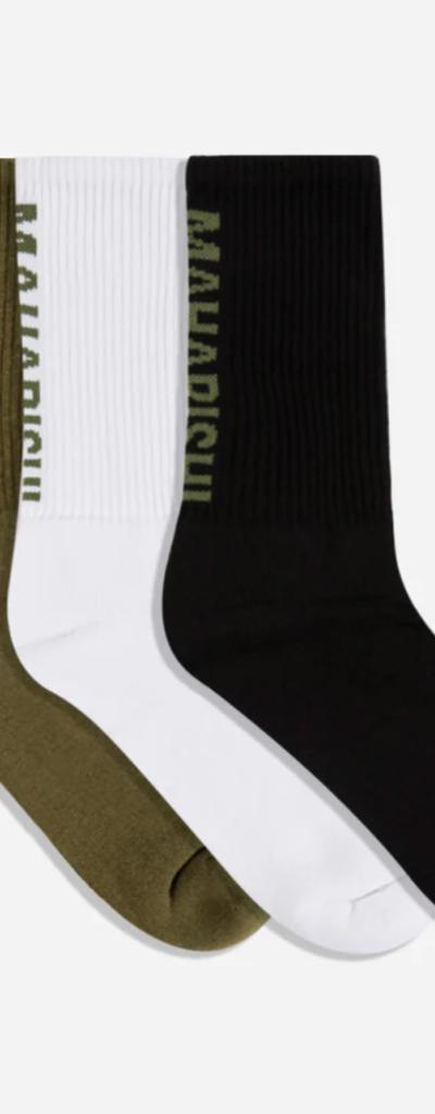 Green, white and blacks Marahishi crew socks on a white background