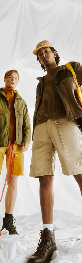 Two people together wearing brown Fjallraven clothing and gear