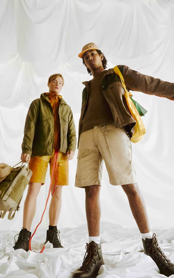 Two people together wearing brown Fjallraven clothing and gear
