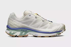 A white pair of Salomon Xt-6 shoes with purple and green details
