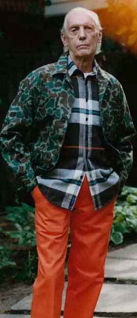 An older man wearing a camo print Noah jacket and orange pants