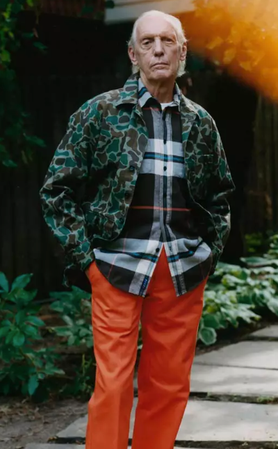 An older man wearing a camo print Noah jacket and orange pants
