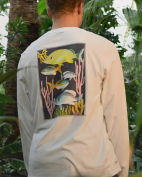 Man in nature wearing white long-sleeve Tentree T-shirt with a Fish print on the back