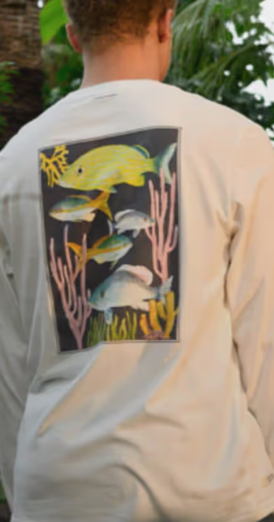 Man in nature wearing white long-sleeve Tentree T-shirt with a Fish print on the back
