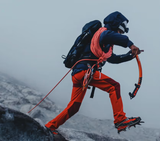 A man doing a high intensity trek on ice with heavy duty Mammut apparel and hiking gear
