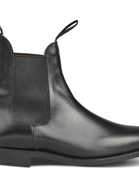 A black pair of handmade Trickers boots that look similar to Blundstones