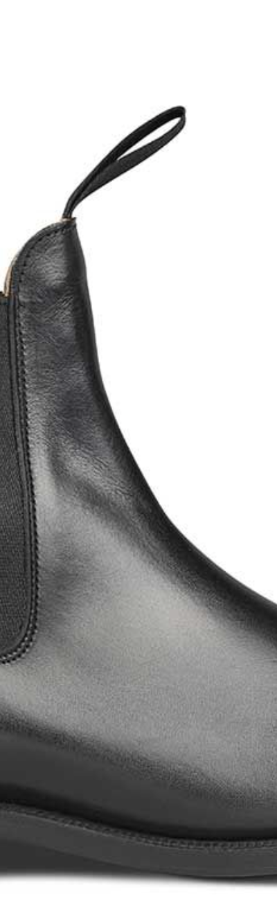 A black pair of handmade Trickers boots that look similar to Blundstones