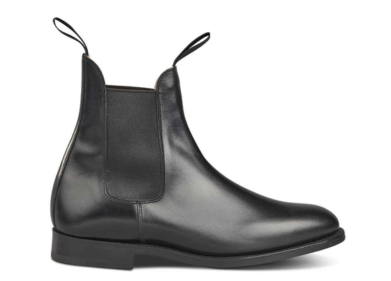 A black pair of handmade Trickers boots that look similar to Blundstones