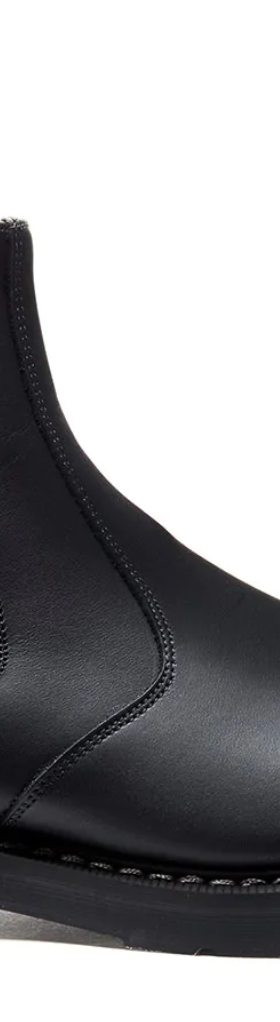A black pair of Solovair boots that look similar to Blundstones on a white backgorund