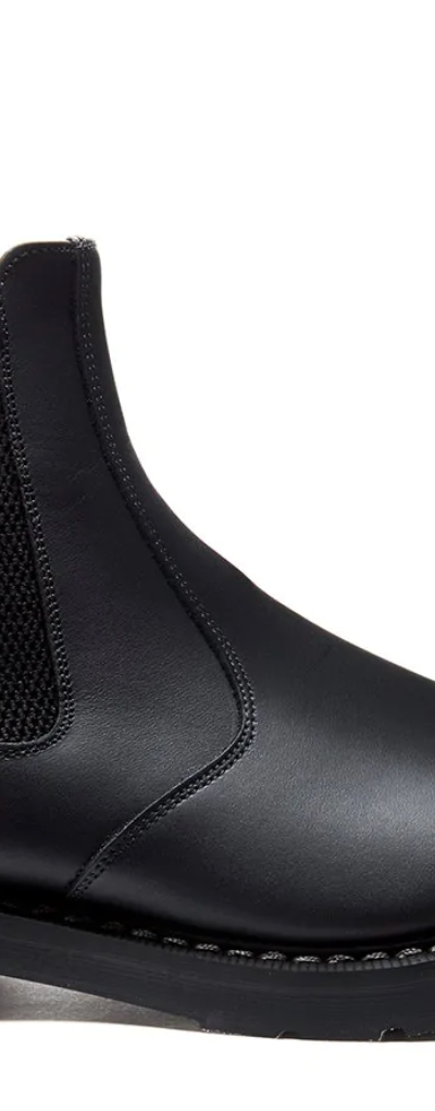 A black pair of Solovair boots that look similar to Blundstones on a white backgorund