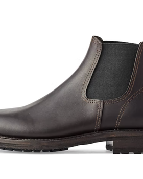 A black pair of contemporary Filson black boots on a white background