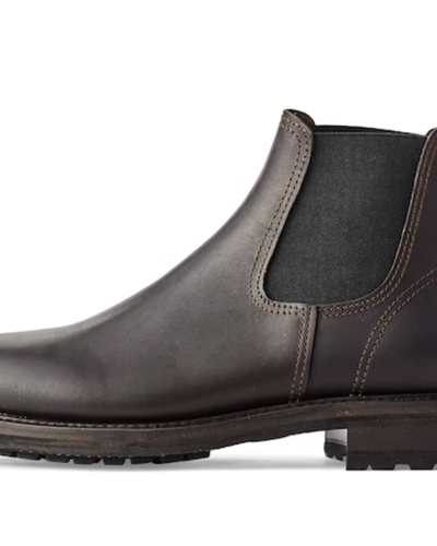 A black pair of contemporary Filson black boots on a white background