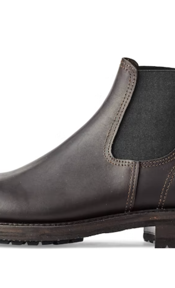 A black pair of contemporary Filson black boots on a white background