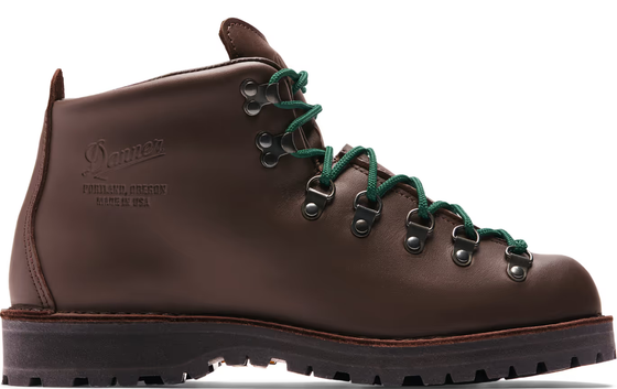 A brown pair of Danner boots with Green laces on a white background