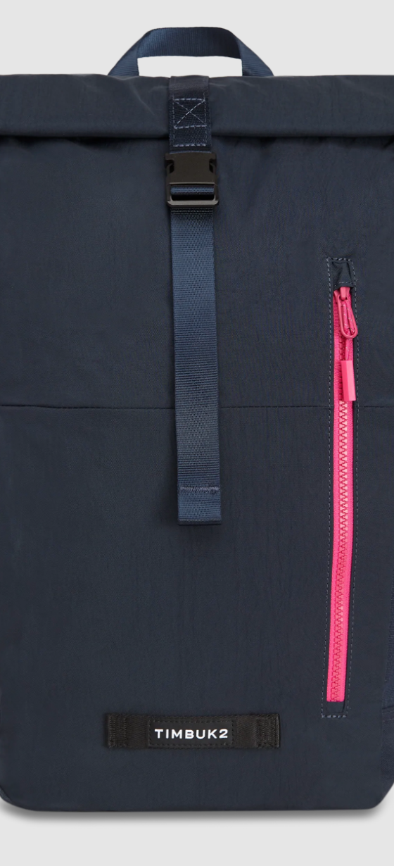 A black Timbuk2 backpack with a red zipper on a white background