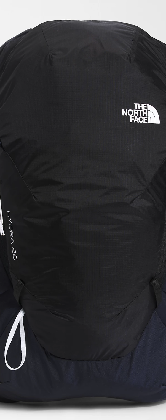 A black North Face travel bag on a white background