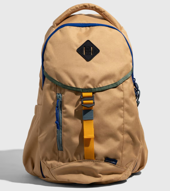 A beige United By Blue backpack with dark blue features on a white background