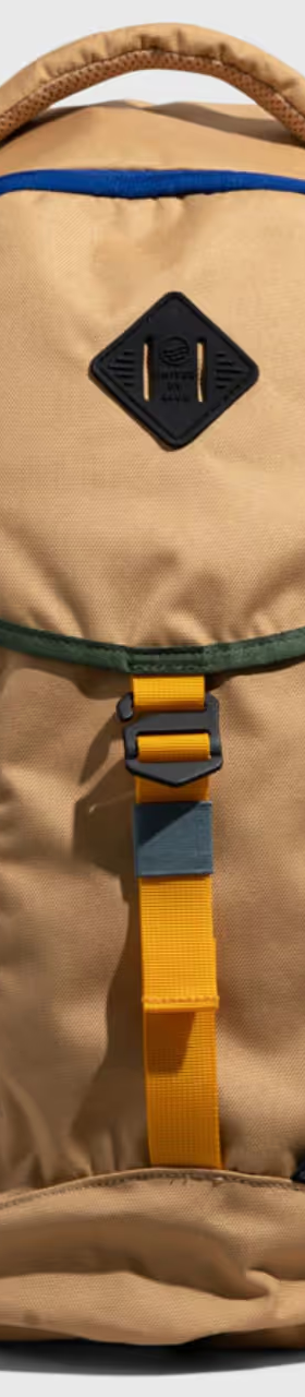 A beige United By Blue backpack with dark blue features on a white background