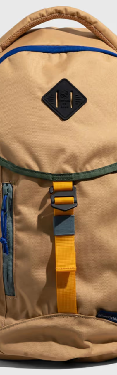 A beige United By Blue backpack with dark blue features on a white background