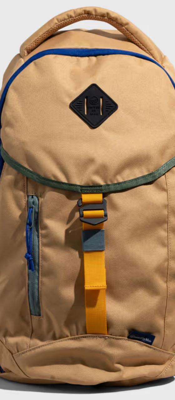 A beige United By Blue backpack with dark blue features on a white background