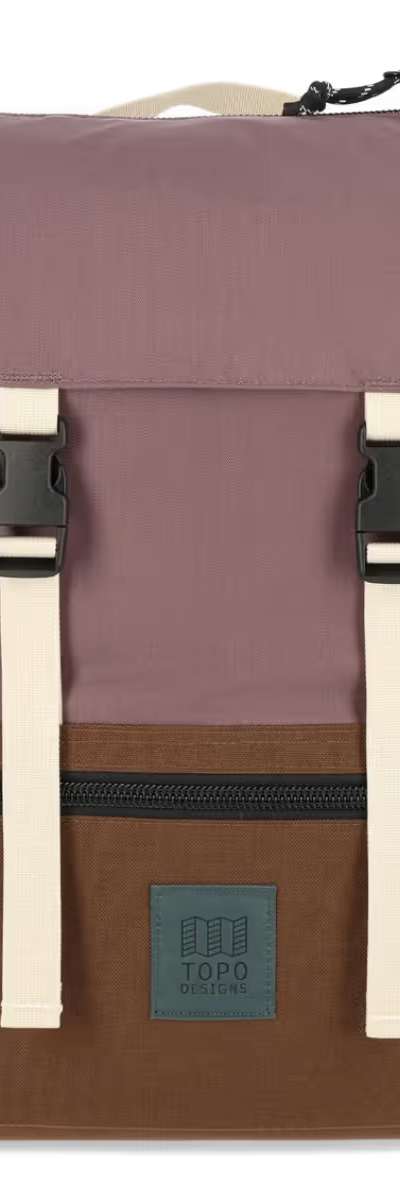 A brown and light purple rucksack backpack from Topo Designs on a white background