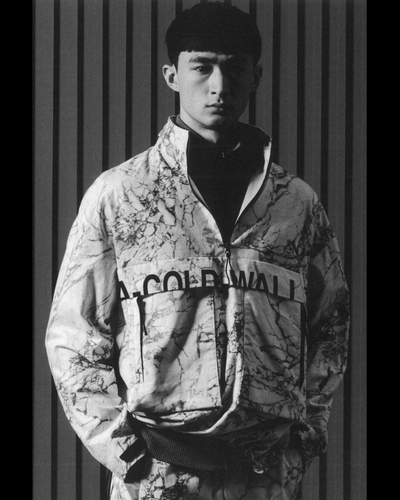 A man wearing a camo-styled A-COLD-WALL jacket with matching pants and a black fleece underneath