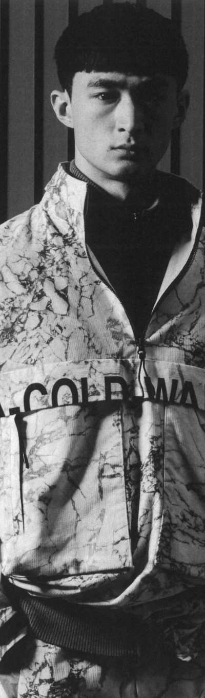 A man wearing a camo-styled A-COLD-WALL jacket with matching pants and a black fleece underneath