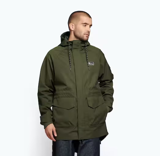 A man wearing a dark green Penfield winter jacket with dark jeans