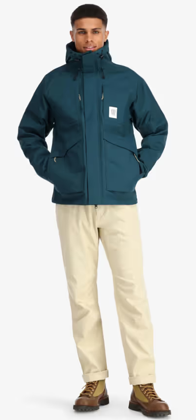 A man wearing a Teal Topo Designs Winter Jacket with Khaki pants and Danner boots