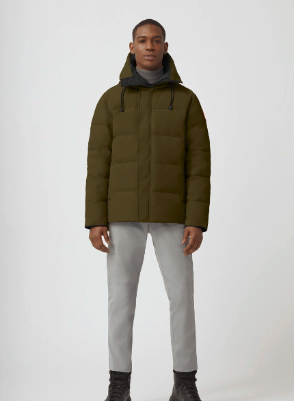 A man wearing an olive Canada Goose down jacket and grey pants