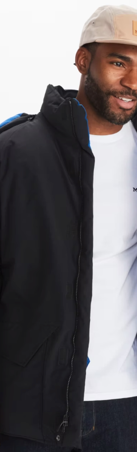 A man wearing a Marmot outfit feating a white t-shirt, black winter coat and a beige hat