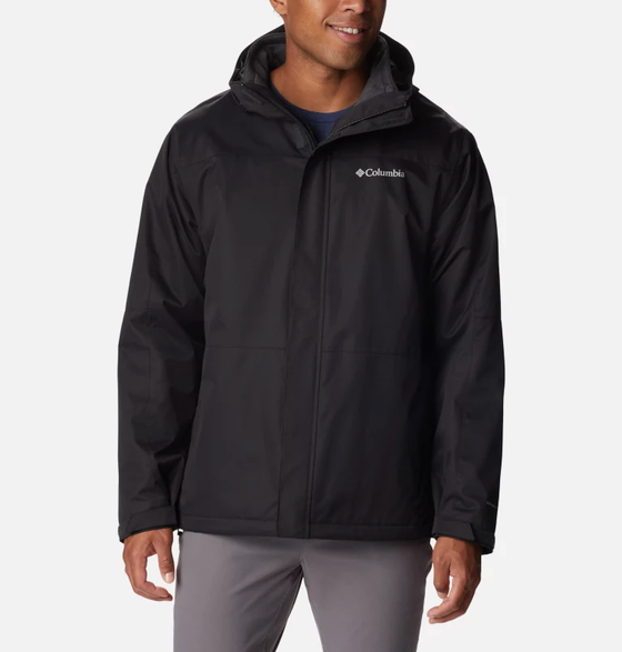 A man wearing a black Columbia winter jacket and dark grey pants