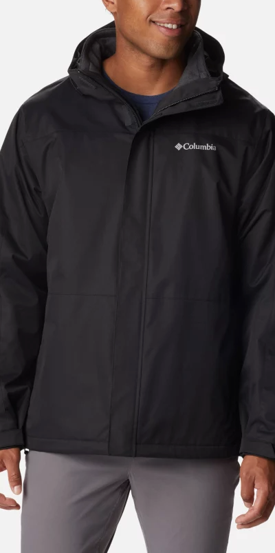 A man wearing a black Columbia winter jacket and dark grey pants