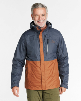 A man wearing a brown and navy blue LL Bean winter jacket and olive green pants