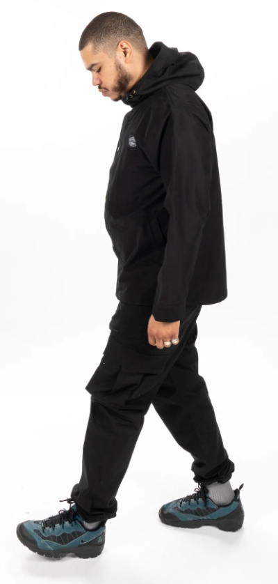 A man wearing an all-black Poler outfit feating a winter jacket and pants