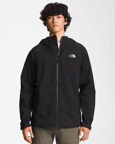A man wearing a black North Face winter jacket and green pants