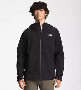 A man wearing a black North Face winter jacket and green pants