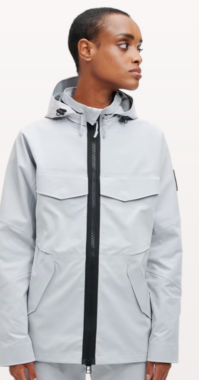 A woman wearing a light grey futuristic, contemporary On-Running Jacket
