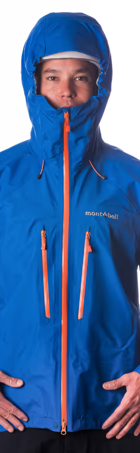 A man wearing a blue Monbell Winter jacket with the hood on