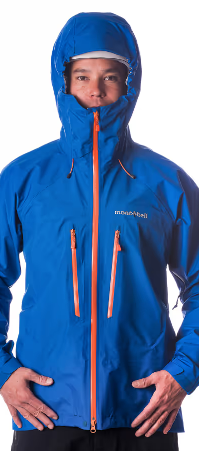 A man wearing a blue Monbell Winter jacket with the hood on