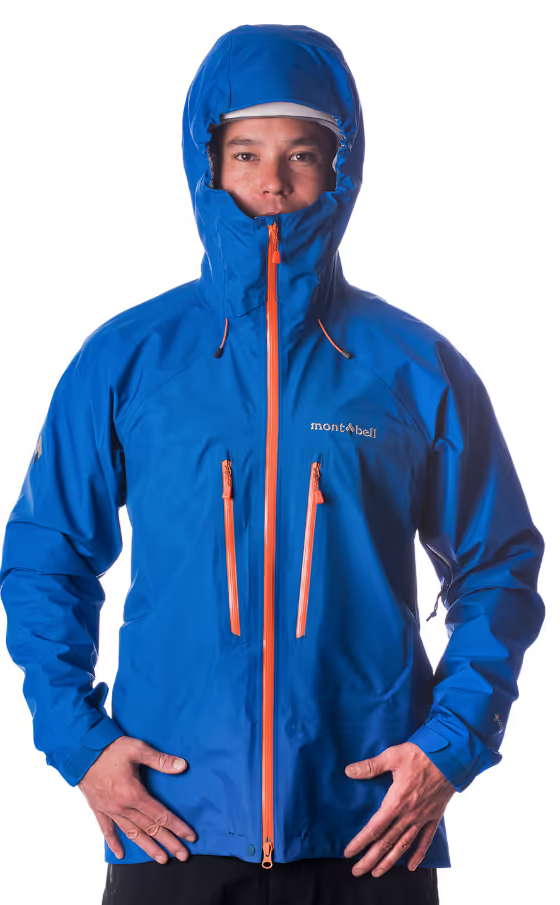 A man wearing a blue Monbell Winter jacket with the hood on