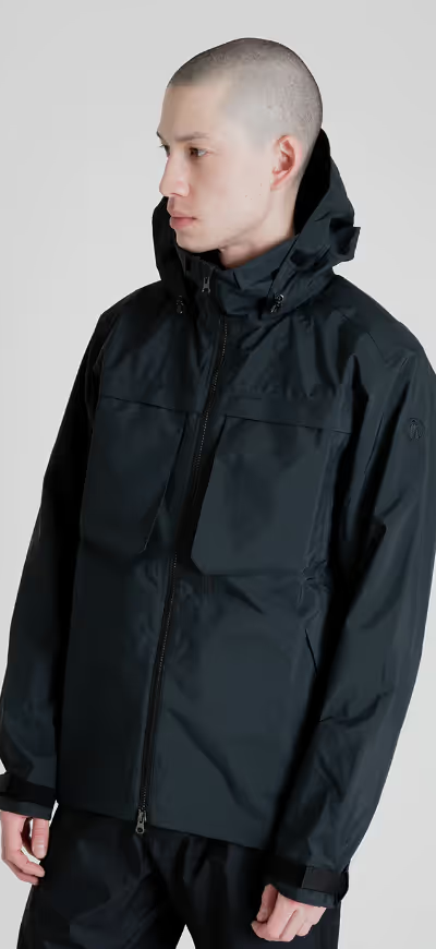 A man wearing a black Tilak winter jacket with matching pants