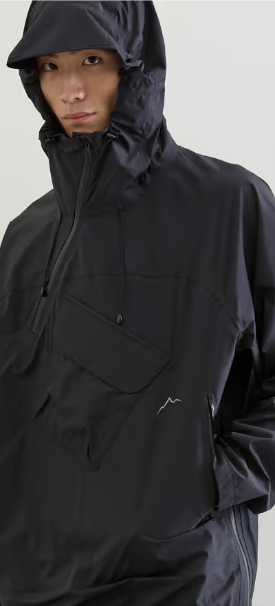 A man wearing a black CAYL jacket with his hood on
