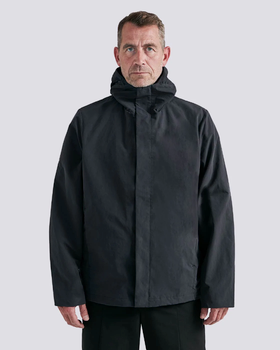 A man wearing a black Arys winter jacket and black pants